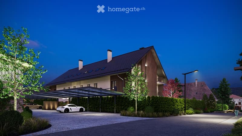 Modern two-story house with a sloped roof, wooden facade, and covered driveway. Features include a garage, landscaped garden, and parked cars.