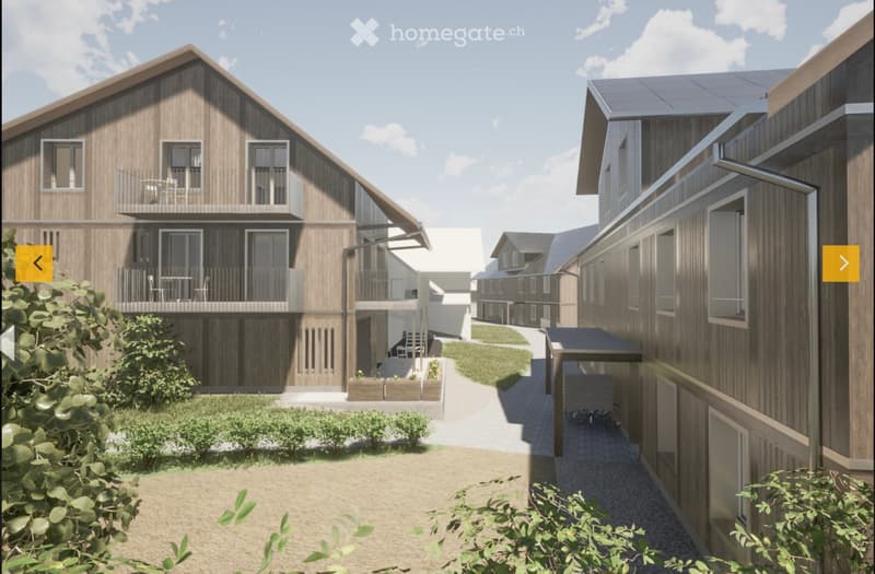 A modern residential complex with wooden facades, multiple balconies, and a central pathway surrounded by greenery.