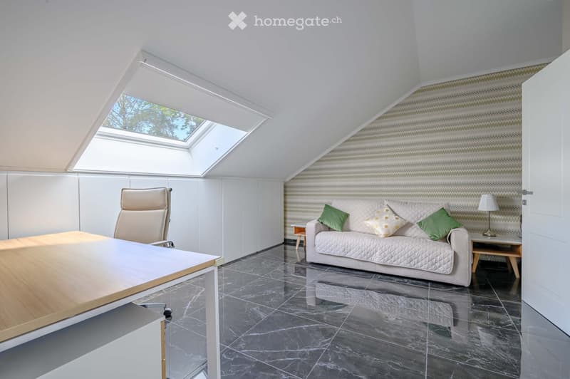 Furnished Room. A modern office space with a desk, office chair, and a couch with pillows. The room has a marble floor and a skylight window.