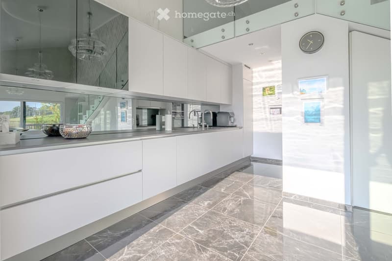 Other. {"visible_features":[],"type":"Kitchen","objects":["cabinet","sink","faucet","microwave","coffee machine","clock","picture frame","vase","roll of paper towels","roll of tissue paper","roll of kitchen paper","roll of plastic bags","roll of aluminum