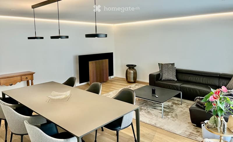 contemporary dining area with a long dining table and chairs, black leather sofa, coffee table, black flat screen TV, decorative items, wooden flooring