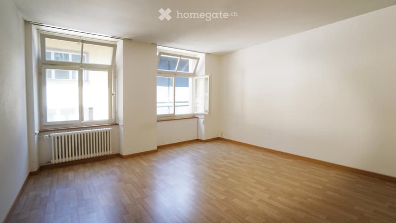 empty room, wooden floor, white walls, two windows, radiator