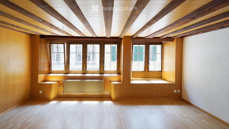 empty room, wooden floor, wooden walls, wooden beams, windows, radiator