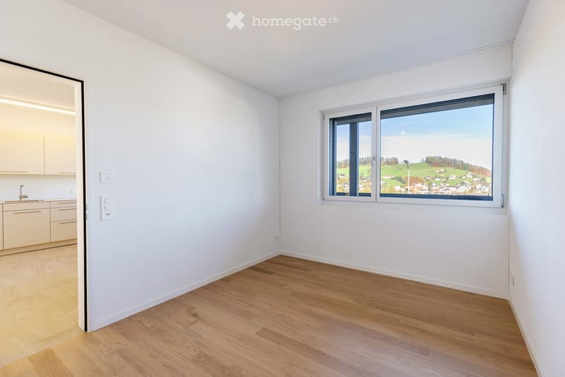 Empty room with large window and view of mountains