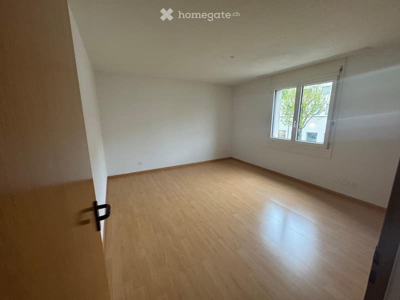 Empty room with wooden flooring, white walls, and a window with blinds. No furniture or equipment is present.