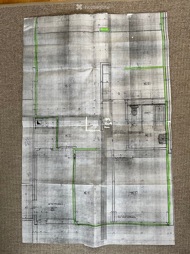 Floor plan of a residential building showing multiple rooms, including living areas, bedrooms, bathrooms, and a staircase. Dimensions and room labels are indicated.
