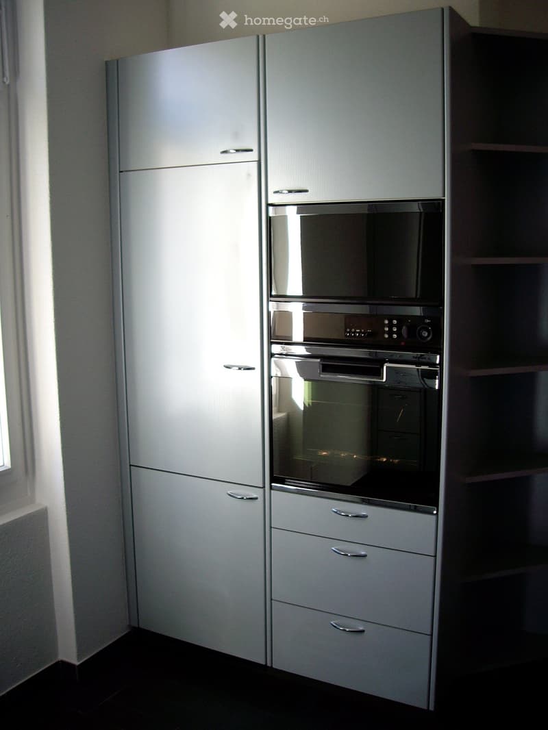 white kitchen cabinets, stainless steel microwave, stainless steel oven, drawers, shelves