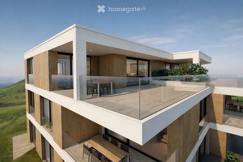 Modern two-story building with large glass balconies, wooden decking, and outdoor dining tables and chairs on both levels.