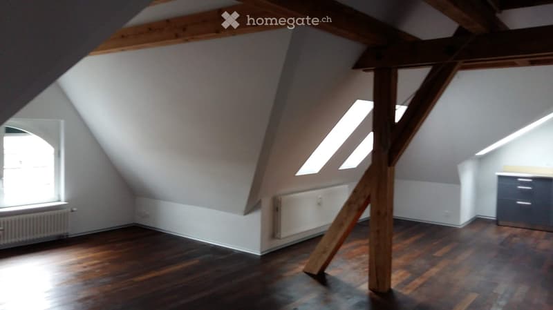 Unfurnished Room. An attic space with wooden beams, wooden flooring, and skylights. The room is empty, with no furniture or furnishings visible.