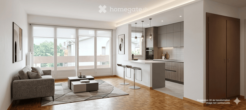 Modern open-plan living and dining area with a grey sofa, coffee table, and kitchen island. Large windows offer a view of greenery outside.