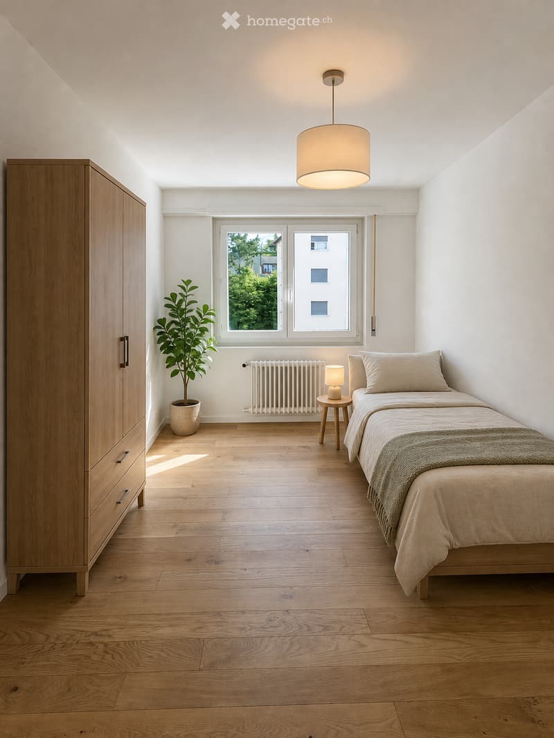 Minimalist bedroom with light wooden flooring, a single bed with beige bedding, a wooden wardrobe, a small side table with a lamp, and a potted plant near the window.