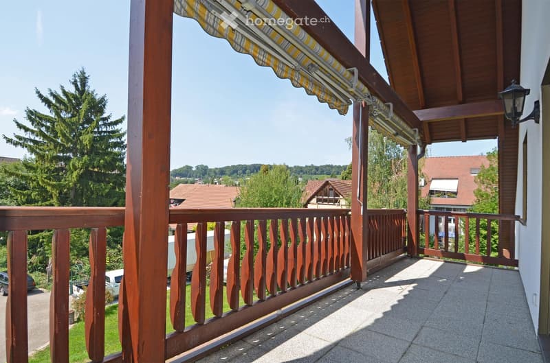 wooden balcony with a retractable roof and view of the landscape