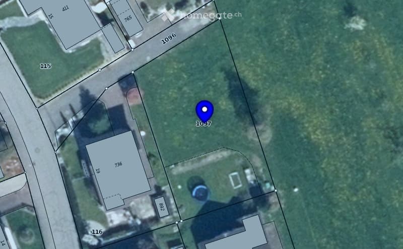 Aerial view of a residential lot with a marked building footprint and surrounding property lines.
