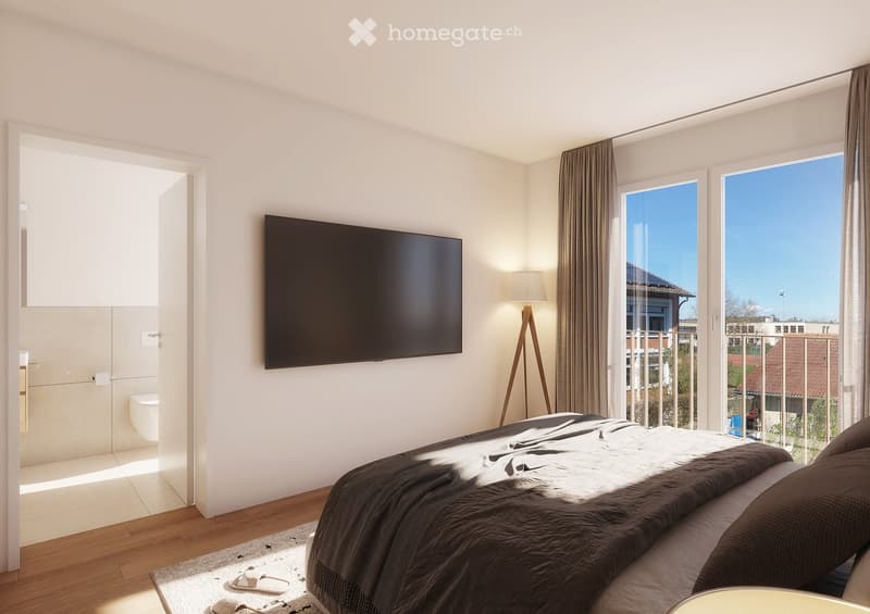 Modern bedroom with a large bed, dark bedding, a wall-mounted TV, floor lamp, and large windows with curtains. A small bathroom is visible through an open doorway.