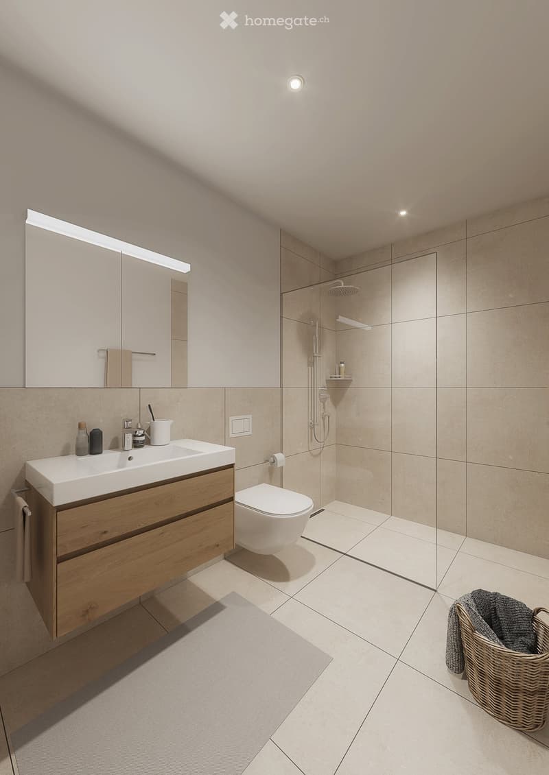 Modern bathroom with a wooden vanity, white sink, toilet, large mirror, and a glass-enclosed shower area.