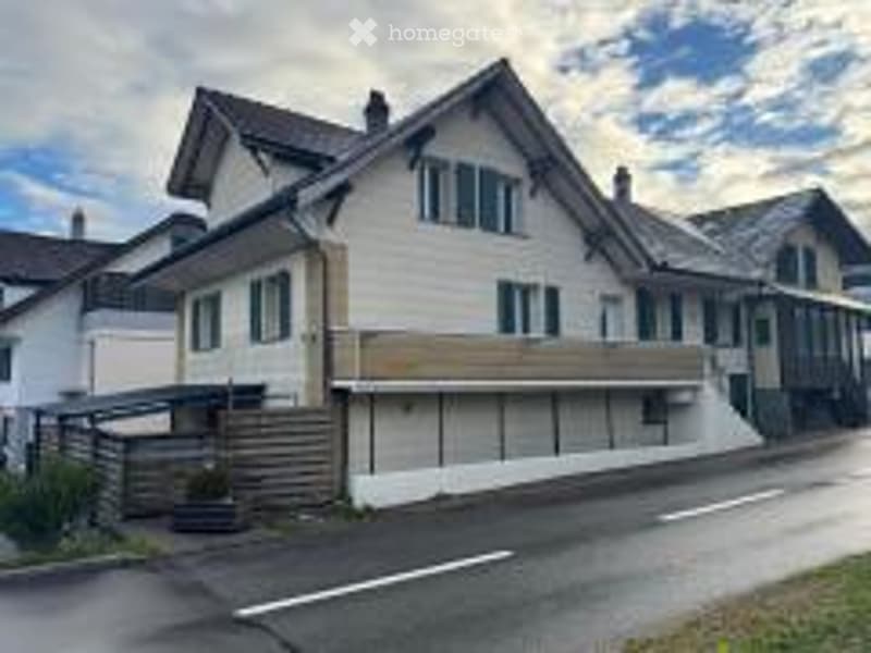 2 story house, white exterior, green shutters, wooden balcony, wooden fence
