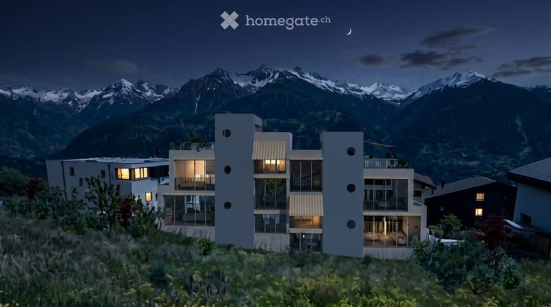 Modern multi-story building with large windows and balconies, set against a backdrop of snow-capped mountains at night.