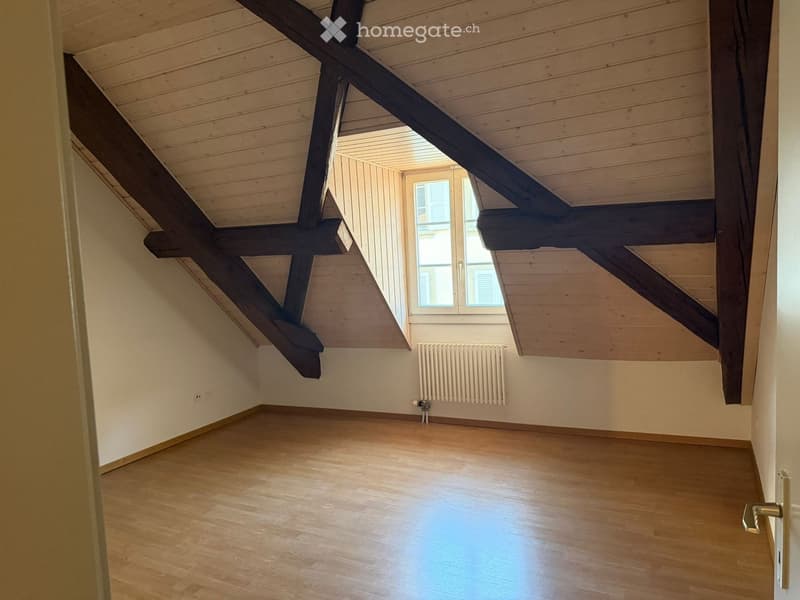 empty room, wooden floor, wooden beams, white walls, window, radiator