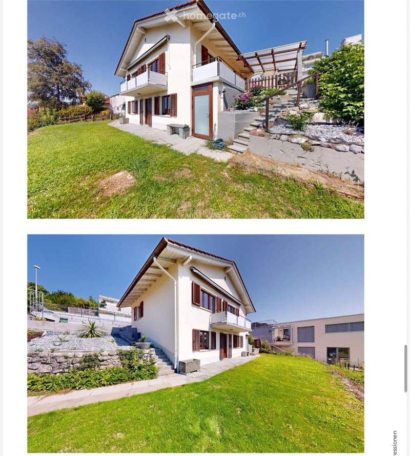 Two-story house with white exterior, brown shutters, and a balcony. The house is surrounded by a well-maintained lawn and stone steps leading to the entrance.