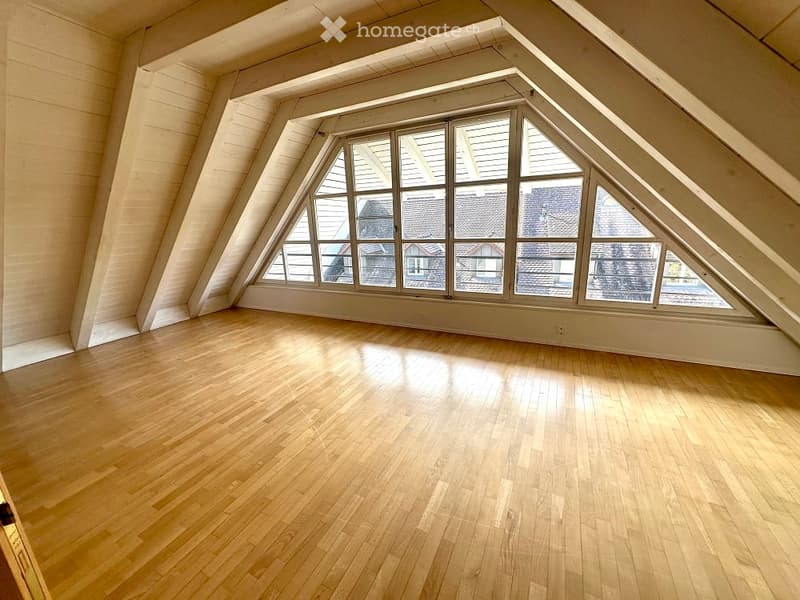 empty room, wooden floors, wooden beams, large triangular window