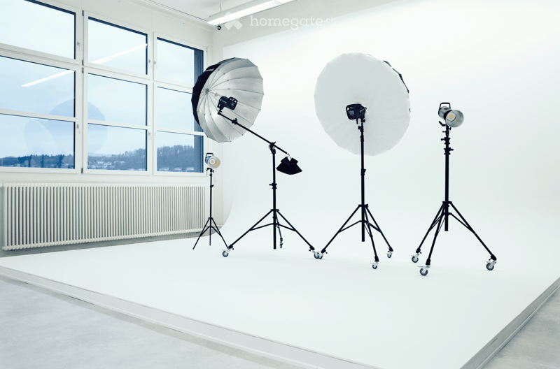 Empty room with large windows, white walls, and a smooth floor. No furniture or equipment present.
