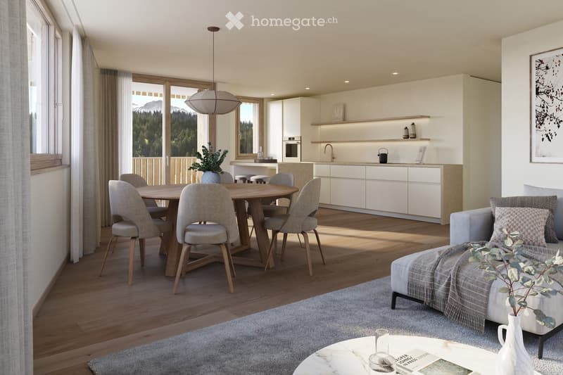 Modern open-plan living and dining area with a view of mountains, featuring a grey sofa, coffee table, dining table with chairs, and a sleek white kitchen with cabinets and appliances.