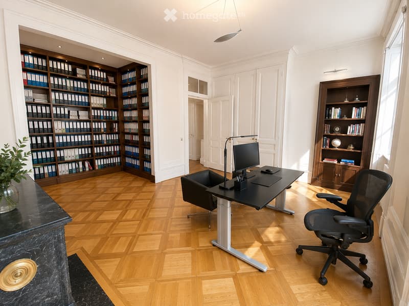 Elegant office with wooden herringbone flooring, large black desk, ergonomic chair, bookshelf filled with binders and books, and a decorative plant on a marble console.