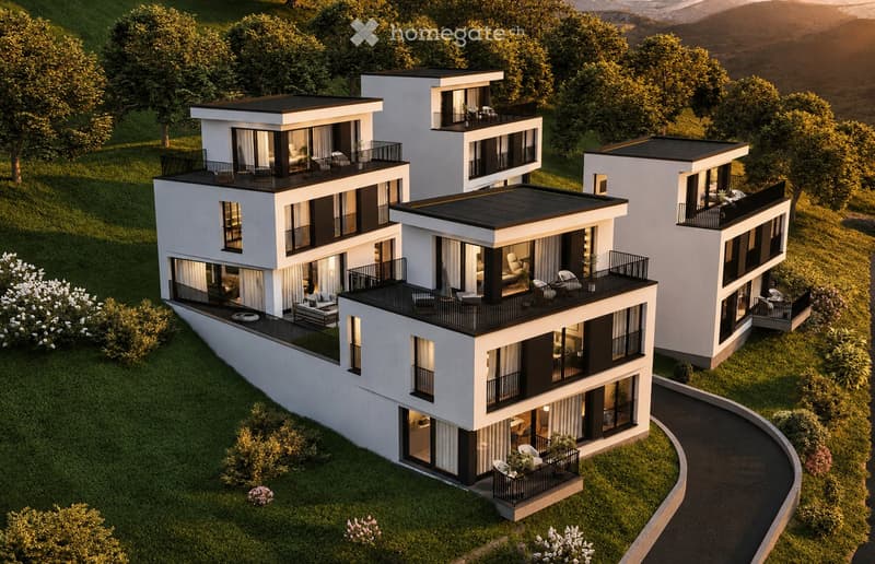 Aerial view of a modern, multi-story residential complex with white and black exterior, featuring balconies, large windows, and a landscaped garden area.
