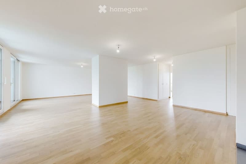 Completely empty room with bare white walls and light wooden flooring. No furniture or equipment.