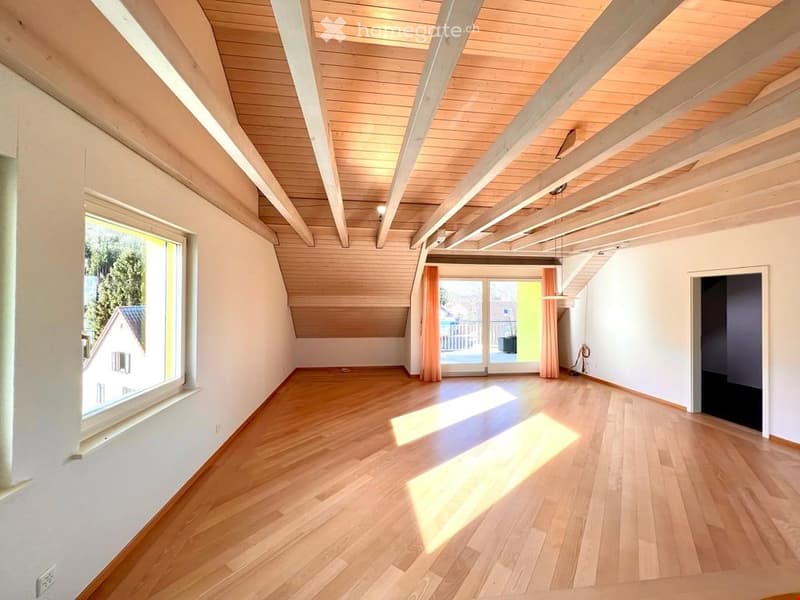 {"visible_features": ["View"],    "type": "Room",    "description": "Spacious attic room, wooden flooring, wooden ceiling beams, large window with curtain, door leading to balcony with railing",    "localized_descriptions":        {        "EN": "Spa