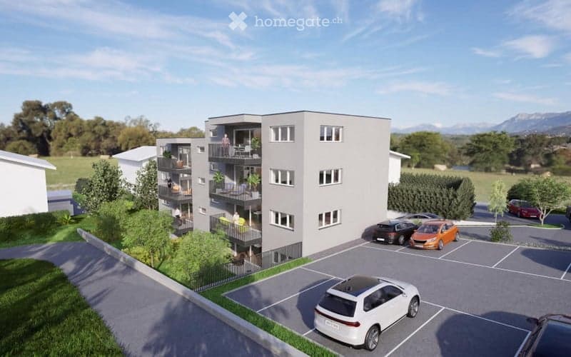 3-story residential building with balconies, surrounded by greenery and parking area.
