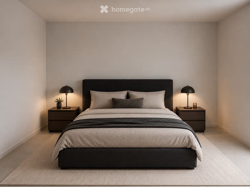 Modern bedroom with a large bed, nightstands, lamps, and a small potted plant. The room features light-colored walls and a wooden floor.