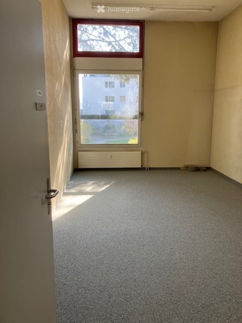 Empty room with a window, radiator, and a door