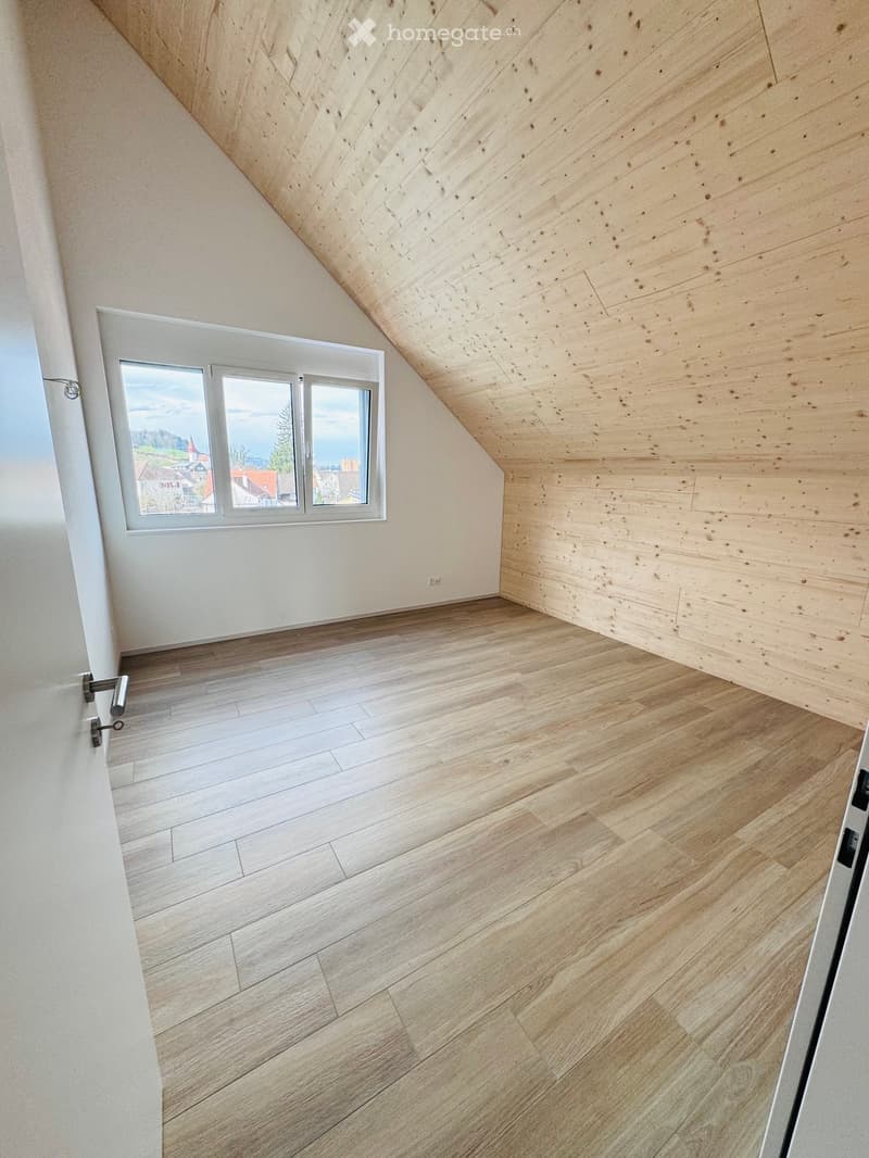 empty room with wooden ceiling, wooden floor, window