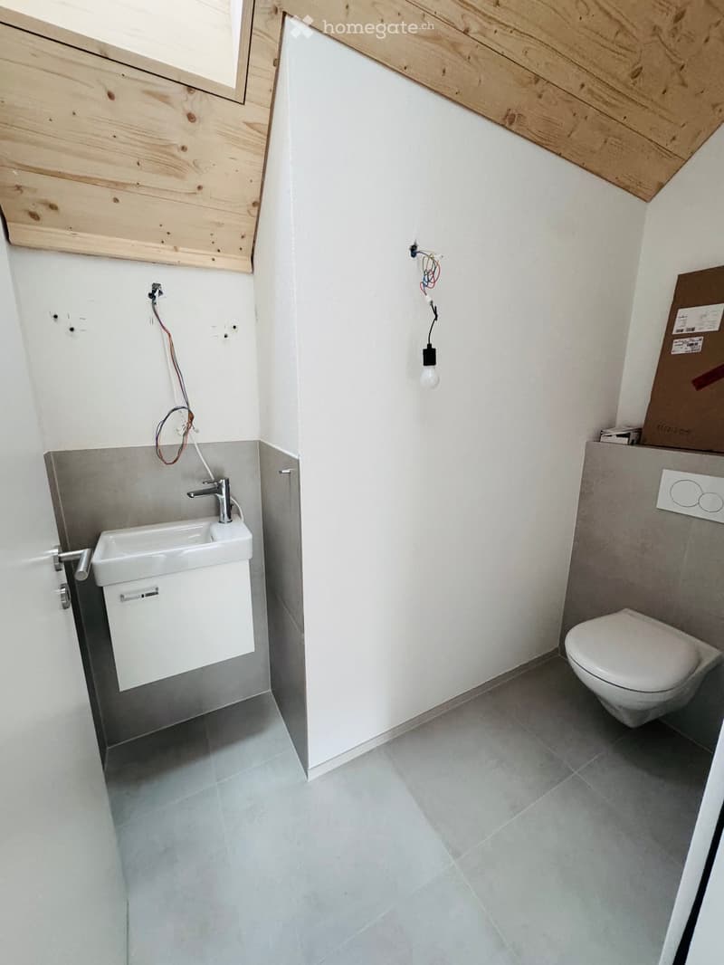 small bathroom with sink, toilet, tiled floor, wooden ceiling