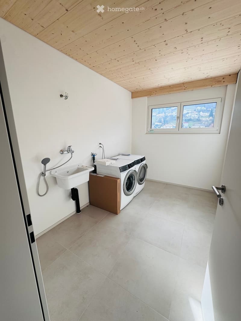 small laundry room, with washing machine, sink, tiled floor, wooden ceiling