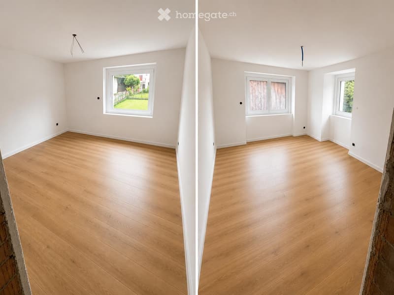 Two adjacent unfurnished rooms with light wooden flooring, white walls, and large windows offering views of a garden and outdoor area.
