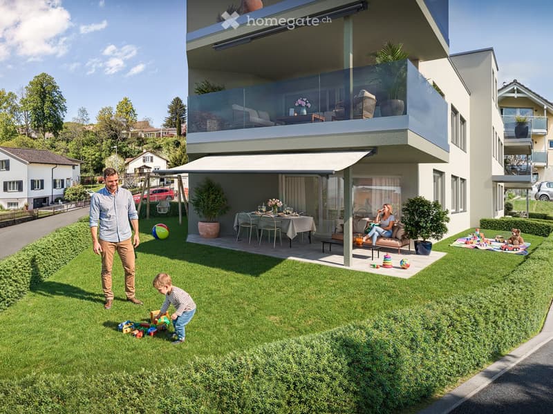 Family-friendly garden area with a modern house, green lawn, outdoor seating, and toys.