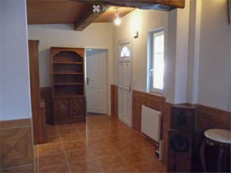 wooden cabinet, radiator, tiled floor, two white doors, window