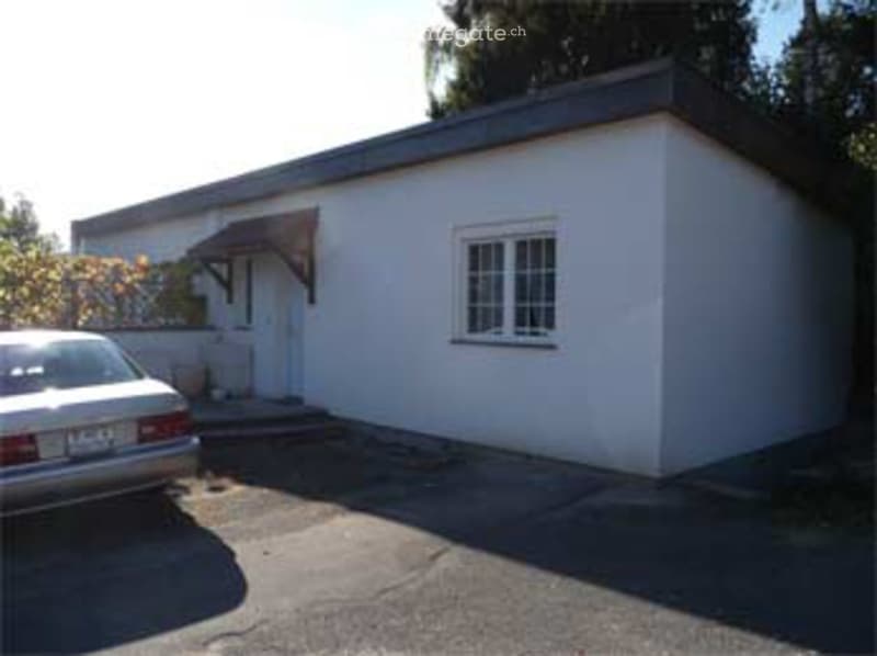 white exterior, single story, single window, car parked in front