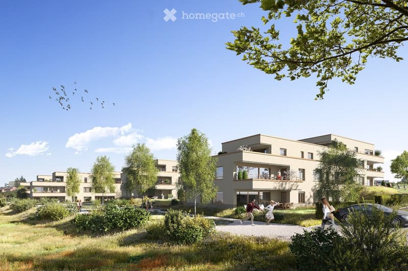 Modern residential complex with multiple buildings, balconies, greenery, and a parking area.