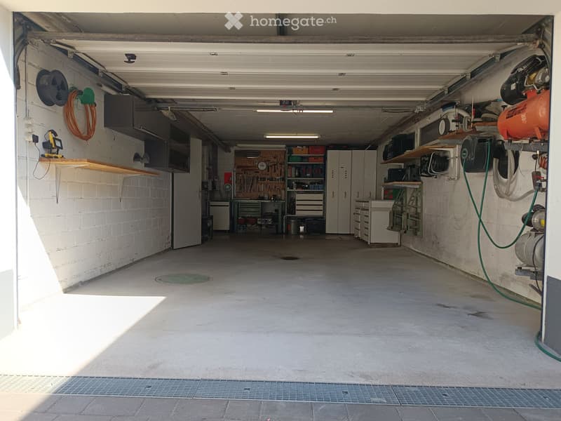 {"type": "Garage", "objects": [], "description": "Well-lit garage with white brick walls, concrete floor, and various tools and equipment stored on shelves and workbenches.", "localized_descriptions": {"EN": "Well-lit garage with white brick walls, concre