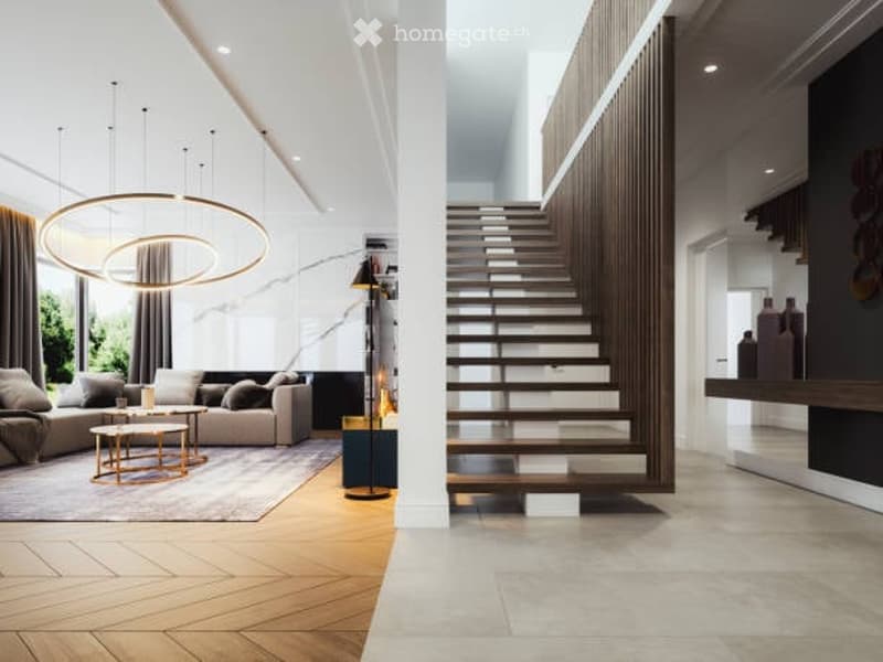 Modern living room with a large circular pendant light, a comfortable sofa, a coffee table, side tables, and a sleek wall-mounted shelf. The space features a mix of wooden and marble flooring, large windows with curtains, and a contemporary aesthetic.