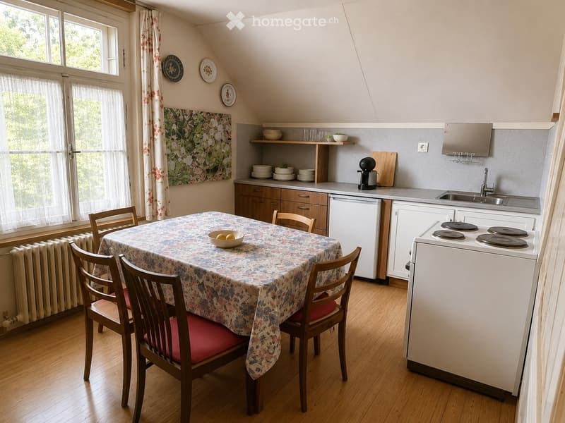 Bright kitchen with wooden flooring, white cabinets, and a small dining area. Features include a table with a floral tablecloth, four wooden chairs, a refrigerator, dishwasher, sink, stove, and various kitchen items on the counter.