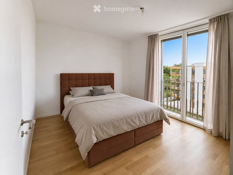 Modern bedroom with a large bed, headboard, pillows, and a view through large windows and sliding doors leading to a balcony.
