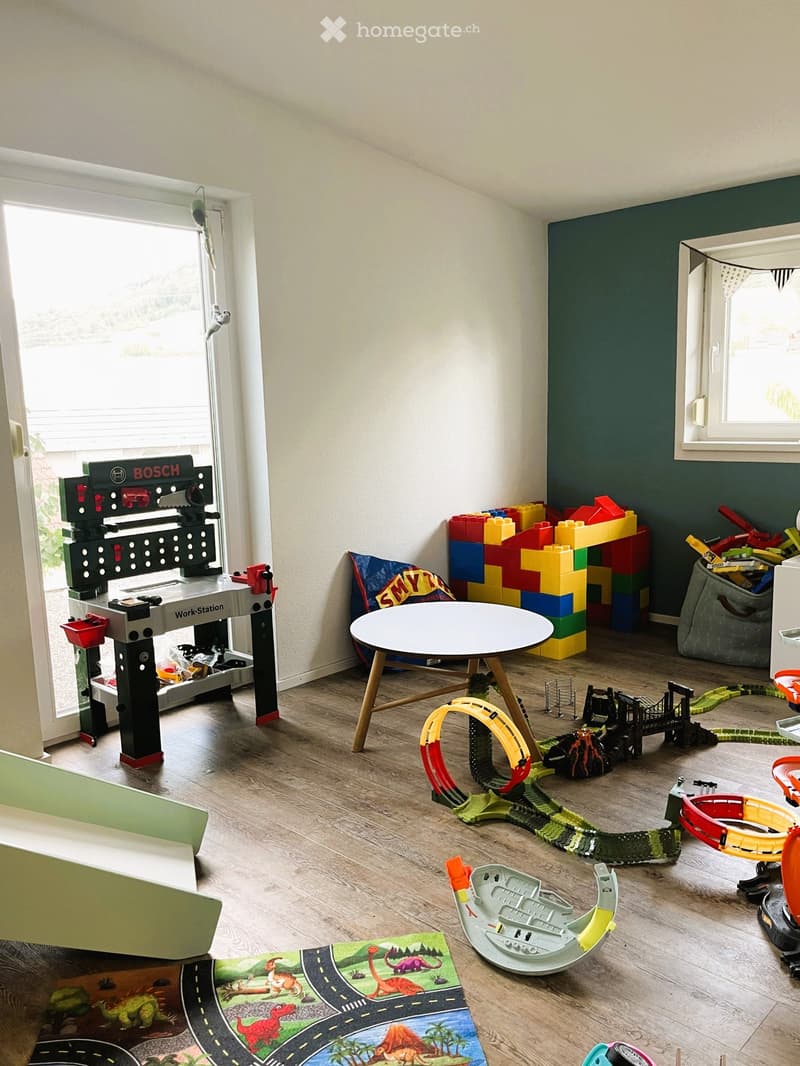 {"type": "Furnished Room", "objects": ["table", "toy train set", "toy blocks", "toy car track", "toy car", "toy station", "toy airplane", "toy castle", "toy airplane", "toy airplane", "toy airplane", "toy airplane", "toy airplane", "toy airplane", "toy ai
