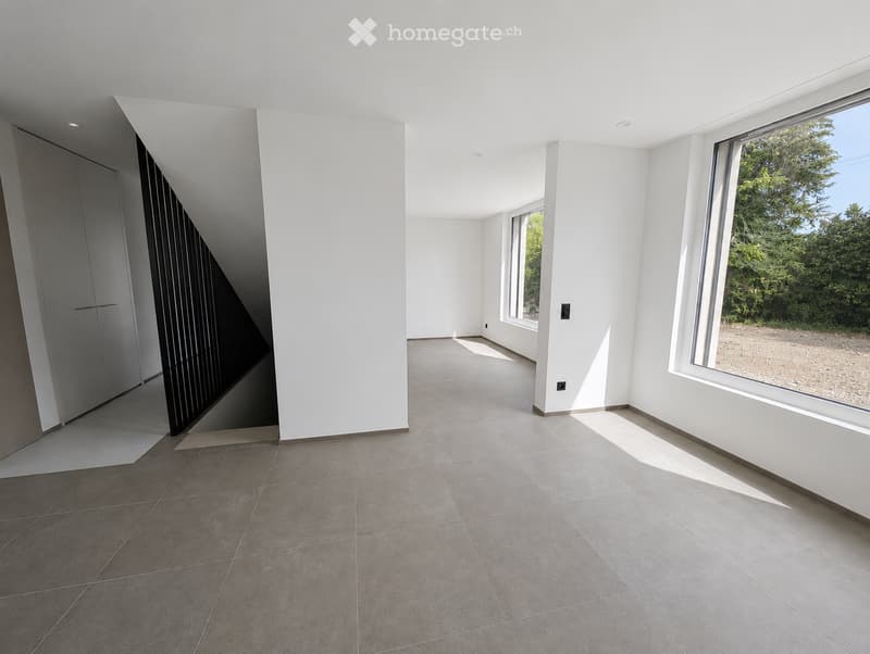 Empty room with white walls, large windows, and tiled floor. No furniture or equipment present.