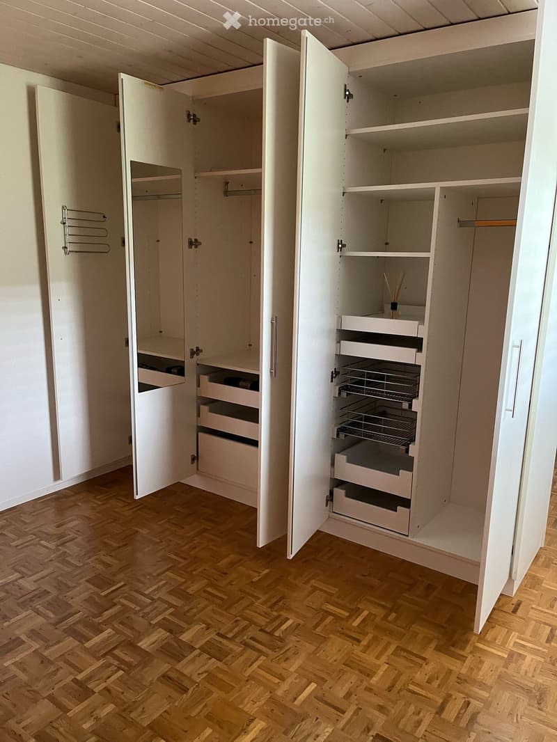 large white wardrobe, wooden floor, open drawers