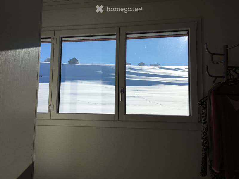window, view of snowy hills and small houses