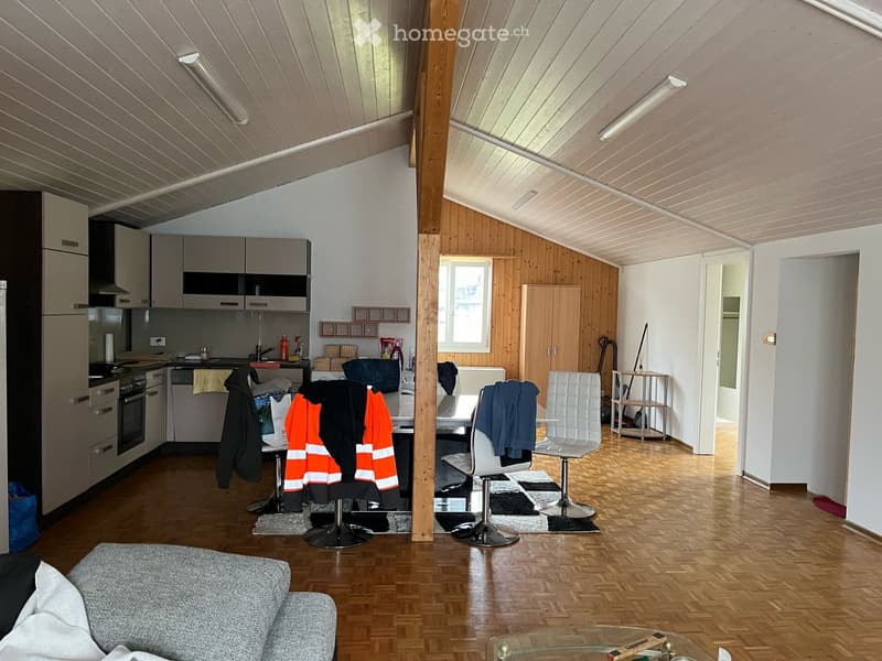 kitchen with dining table, couch with pillows, parquet flooring, white walls, white ceiling, wooden columns, mounted lights